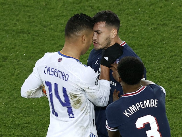 Paris Saint-Germain's (PSG) Leandro Paredes clashes with Real Madrid's Casemiro on February 15, 2022
