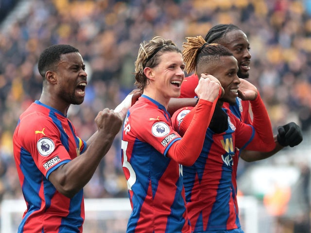 Crystal Palace's Wilfried Zaha celebrates scoring their second goal with Jean-Philippe Mateta, Conor Gallagher and Marc Guehi on March 5, 2022