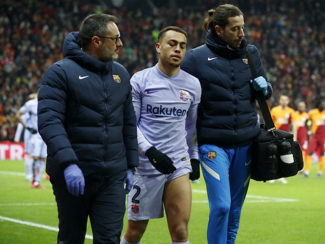 Barcelona's Sergino Dest walks off the pitch after sustaining an injury on March 17, 2022