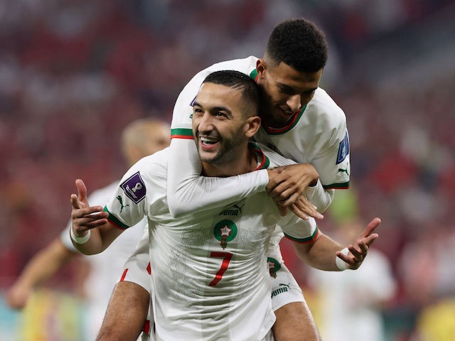 Morocco's Hakim Ziyech celebrates scoring their first goal with Azzedine Ounahi on December 1, 2022